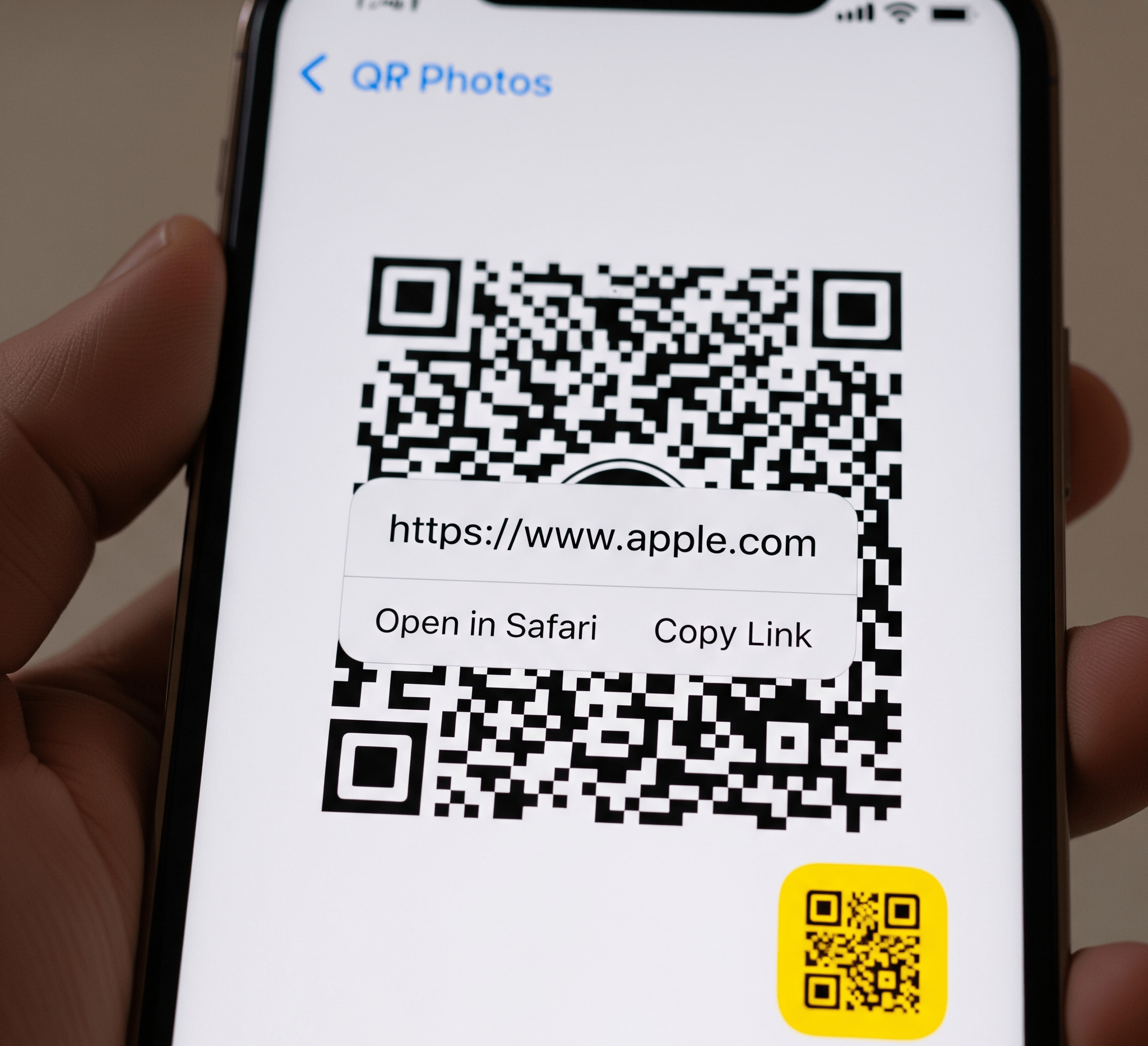 A screenshot of an iPhone screen showing the Photos app. A QR code is visible in the image, and a yellow QR code icon has appeared in the corner, with a pop-up displaying the decoded link.